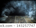 Dark room with smoke over wooden surface 143257747