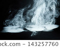 Swirling white smoke forming abstract shapes on black background 143257760