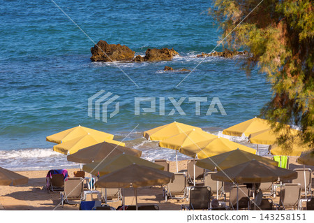 Beach with yellow umbrellas on the Mediterranean coast of Crete, Greece Beach with yellow umbrellas on the Mediterranean coast of Crete, Greece 143258151