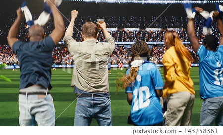 Football fans jumping from joy from couch to celebrate goal at home, watching match on interactive TV broadcast making them feel close to pitch, cheering for winning team, enjoying stadium experience Football fans jumping from joy from couch to celebrate goal at home, watching match on interactive TV broadcast making them feel close to pitch, cheering for winning team, enjoying stadium experience 143258361
