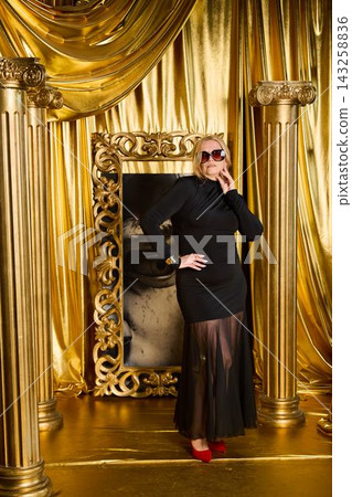 Stylish female leaning on decorated support during celebration Stylish female leaning on decorated support during celebration 143258836