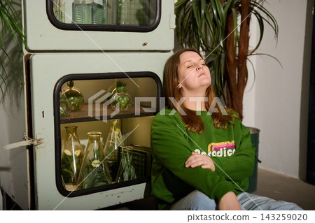 Tranquil young woman with closed eyes and soothing surroundings 143259020