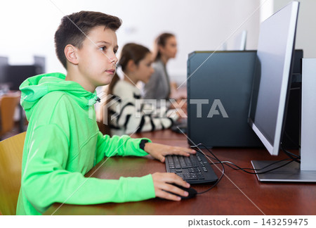 Schoolboy using PC during computer science lesson Schoolboy using PC during computer science lesson 143259475