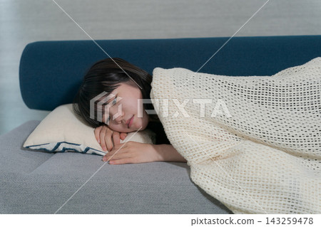 A middle school student sleeping on a sofa A middle school student sleeping on a sofa 143259478