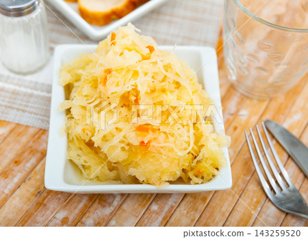 Homemade pickled cabbage on white plate closeup, natural probiotic 143259520