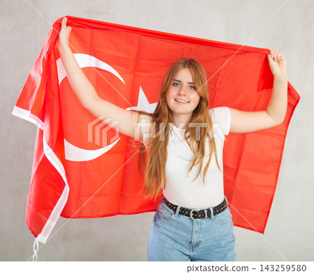 smiling girl in arms raised above head holds cloth of national flag of Turkey smiling girl in arms raised above head holds cloth of national flag of Turkey 143259580