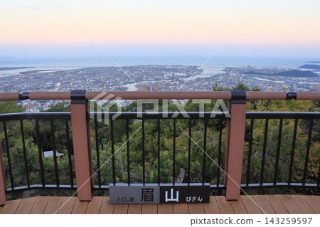 A view of the city before sunset from Mount Bizan in the center of Tokushima City, along with the nameplate of Mount Bizan. A view of the city before sunset from Mount Bizan in the center of Tokushima City, along with the nameplate of Mount Bizan. 143259597