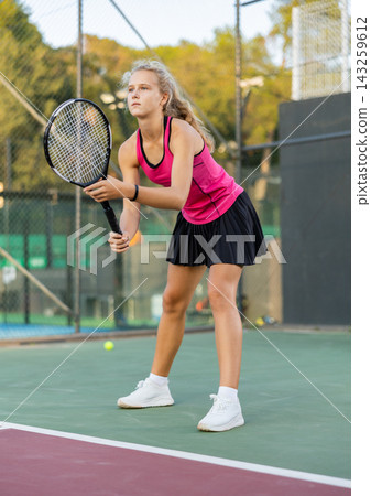 Woman tennis player training on court Woman tennis player training on court 143259612
