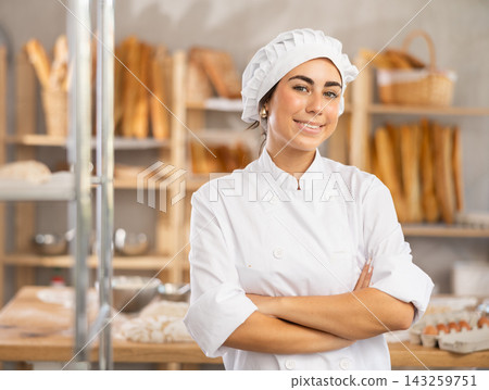 Young female baker posing in workshop Young female baker posing in workshop 143259751