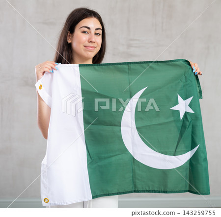 Young woman with flag of Pakistan posing in studio 143259755
