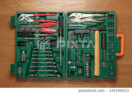 A set of various tools stored in a green hard case. A set of various tools stored in a green hard case. 143260013