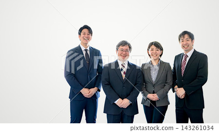 Four smiling business people are lined up on the right side against a white background, with a blank space on the left. Four smiling business people are lined up on the right side against a white background, with a blank space on the left. 143261034