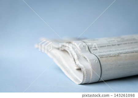 Newspaper folded on top of desk Newspaper folded on top of desk 143261098