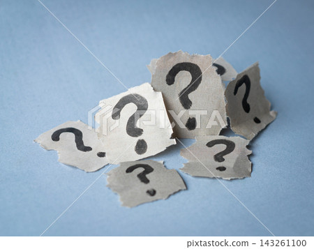Stack of torn papers with question marks. Stack of torn papers with question marks. 143261100