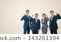 Four businessmen, two men and two women, clenching their fists against a beige background; a large copy space on the left. 143261394