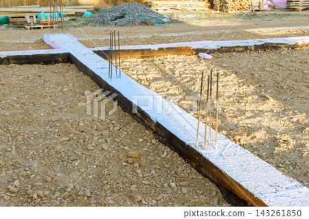 Workers prepare building foundation with rebar, concrete in construction site Workers prepare building foundation with rebar, concrete in construction site 143261850