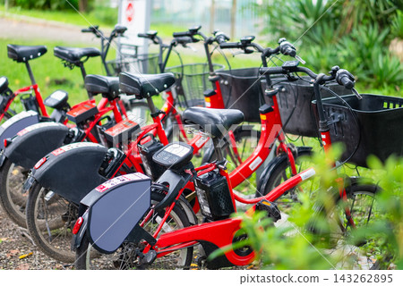 Red shared electric bicycles lined up at parking hubs in the city. Red shared electric bicycles lined up at parking hubs in the city. 143262895