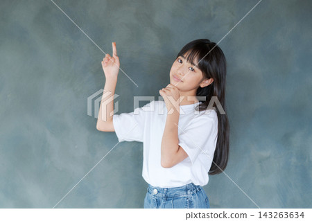 一位正在思考的小學生女孩(灰色背景) 一位正在思考的小學生女孩(灰色背景) 143263634