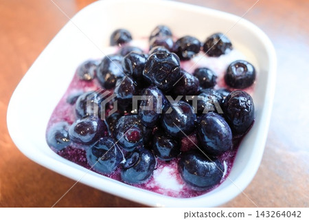 A colorful yogurt breakfast topped with plenty of fresh blueberries. A colorful yogurt breakfast topped with plenty of fresh blueberries. 143264042