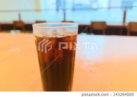 The image of iced coffee with ice and a cool cafe atmosphere. The image of iced coffee with ice and a cool cafe atmosphere. 143264080