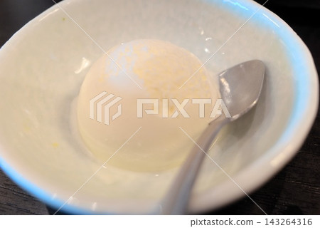 A summer dessert image featuring cool, refreshing ice cream served in a white bowl. A summer dessert image featuring cool, refreshing ice cream served in a white bowl. 143264316