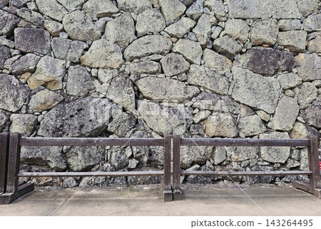 Ancient Himeji Castle stone wall background with wooden fence. Ancient Himeji Castle stone wall background with wooden fence. 143264495