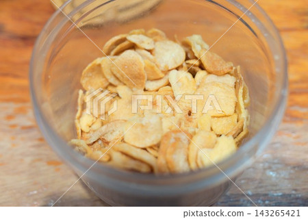 Garlic chips, which are fried garlic used as a topping for dishes. Garlic chips, which are fried garlic used as a topping for dishes. 143265421