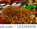 Golden Tinsel and Colorful Christmas Ornaments 143266636