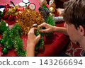 Young Person Making a Christmas Tinsel Wreath at Home 143266694