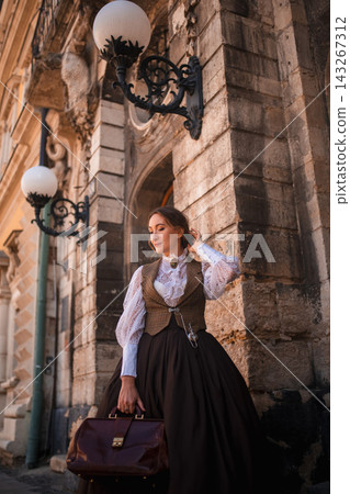 beautiful woman scientist in retro style with a briefcase on the street of the old city beautiful woman scientist in retro style with a briefcase on the street of the old city 143267312