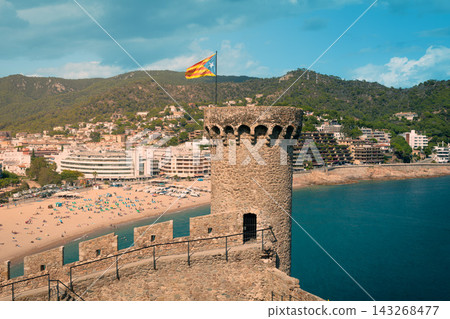 Medieval watchtower and Vila Vella fortress above Tossa de Mar beach in Spain. Iconic Costa Brava landmark for sightseeing Mediterranean vacations and cultural travel Medieval watchtower and Vila Vella fortress above Tossa de Mar beach in Spain. Iconic Costa Brava landmark for sightseeing Mediterranean vacations and cultural travel 143268477