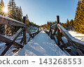 Timber Rafting Bridge (Rechle) near Modrava in Sumava National Park, Czech Republic, covered in snow and illuminated by sunset, connected to the historic Vchynice-Tetov rafting canal. 143268553