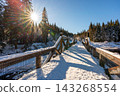 Timber Rafting Bridge (Rechle) near Modrava in Sumava National Park, Czech Republic, covered in snow and illuminated by sunset, connected to the historic Vchynice-Tetov rafting canal. 143268554
