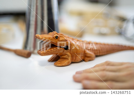 Carved wooden crocodile guiro percussion instrument Carved wooden crocodile guiro percussion instrument 143268751