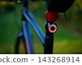 Close-up of a red rear light and reflector on a bicycle 143268914