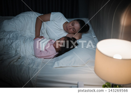 mother and daughter sleeping together and sweet dream in bed at night  143269566