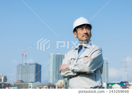 A man in his 50s working on site A man in his 50s working on site 143269698