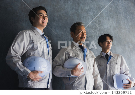 Workers with helmets Workers with helmets 143269731