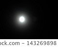 Bright Glowing Full Moon Shining in the Dark Night Sky with Soft Atmospheric Haze and Lens Flare 143269898