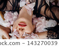 Petals and golden drops on a woman's face and neck 143270039