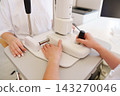Doctor operating professional ophthalmic testing device close-up 143270046