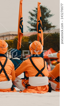 Indian guards in orange uniforms with Sikh flag during Vaisakhi cultural parade Indian guards in orange uniforms with Sikh flag during Vaisakhi cultural parade 143270077