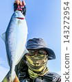 漁夫釣到一條藍魚後欣喜若狂。 143272954