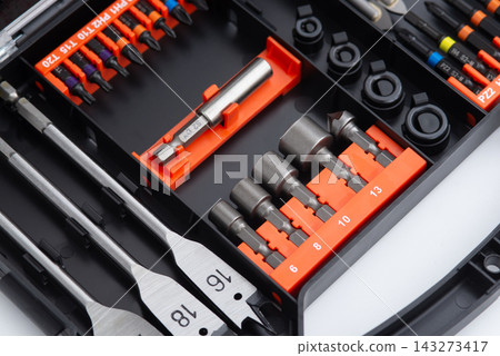 Professional drill bit and socket tool set organized in a compact case for repair and construction work. Professional drill bit and socket tool set organized in a compact case for repair and construction work. 143273417