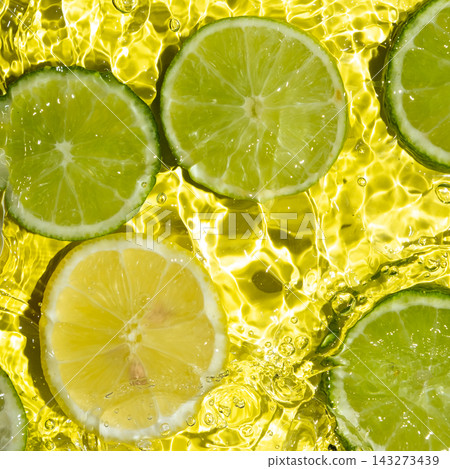 Overhead shot of juicy lemon and lime slices in clear water with ripples Overhead shot of juicy lemon and lime slices in clear water with ripples 143273439