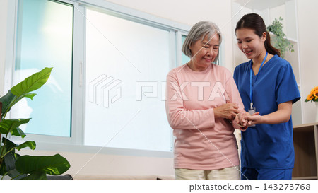 Asian nurse supporting senior woman standing up at home for elder care service 143273768