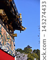 The Inuyama Festival in Aichi Prefecture, Japan: A magnificent procession of elaborate floats called "Kurumayama" and the keep of Inuyama Castle, under a sky full of blooming cherry blossoms. 143274433