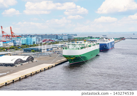 A car carrier docked at anchor and the surrounding scenery (image) A car carrier docked at anchor and the surrounding scenery (image) 143274539