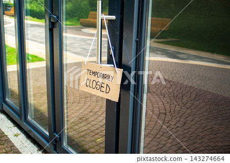 Sign TEMPORARILY CLOSED on welcome door of small shop. Local business closure. Owners facing economic struggles and client loss Sign TEMPORARILY CLOSED on welcome door of small shop. Local business closure. Owners facing economic struggles and client loss 143274664