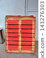 Red Wooden Pallet Leaning Against A White Wall Red Wooden Pallet Leaning Against A White Wall 143276303